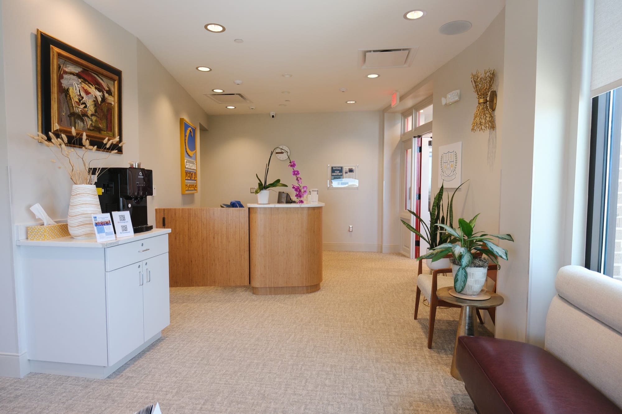 The reception area at Camenzuli Dental Excellence with its coffee station and orchid