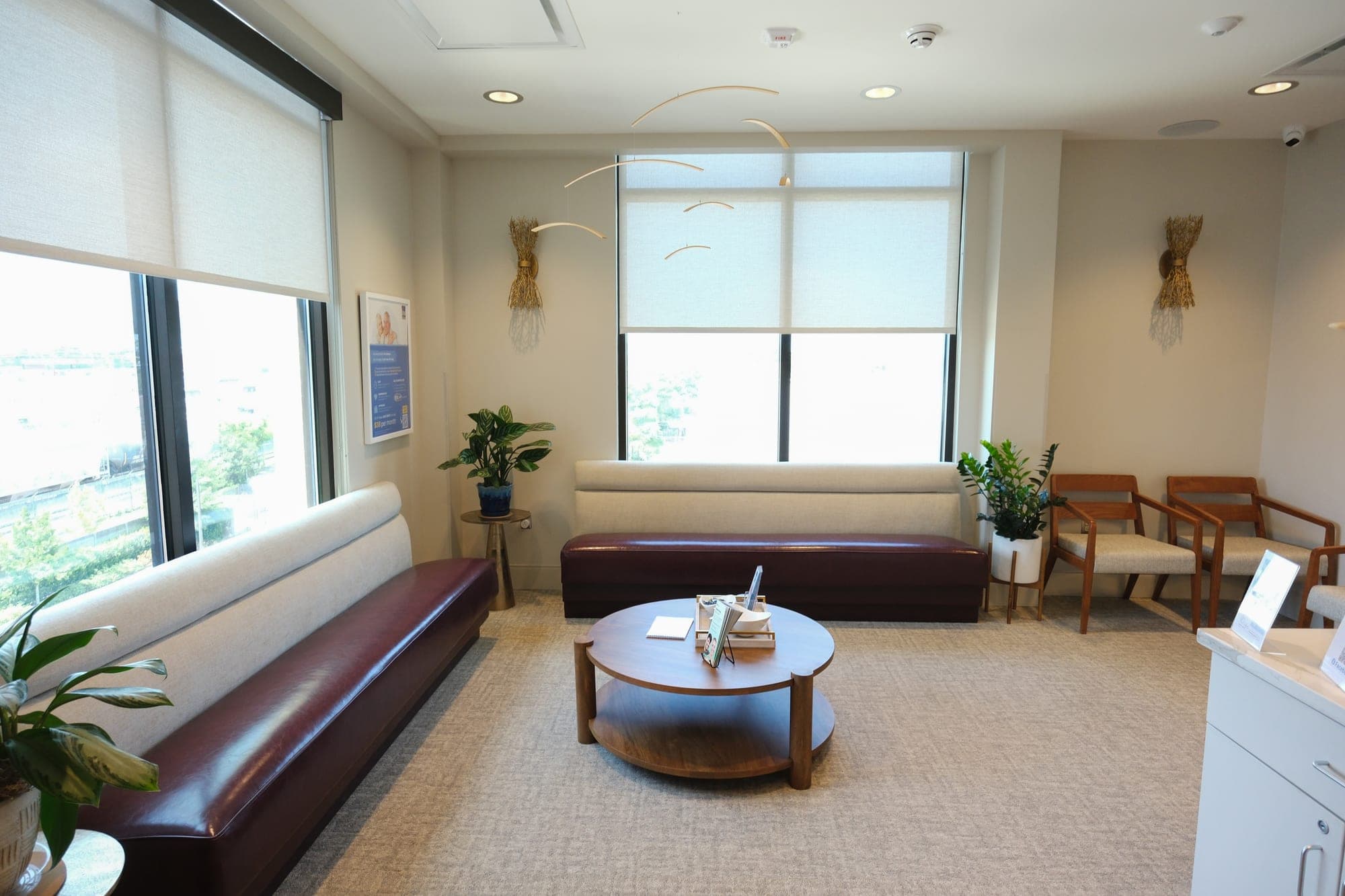 The waiting room at Camenzuli Dental Excellence, with long benches under two windows