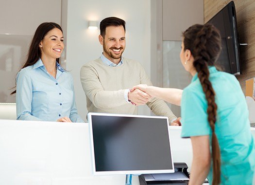 Man and woman checking in at reception desk