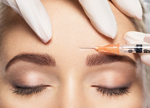 Woman receiving BOTOX in New Orleans between her eyebrows