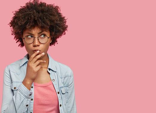 Woman on pink background wondering about braces