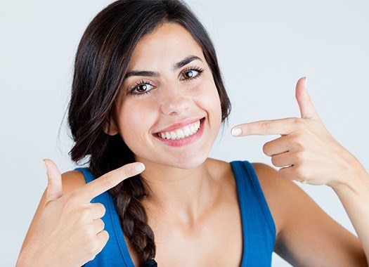 Woman pointing to beautiful smile