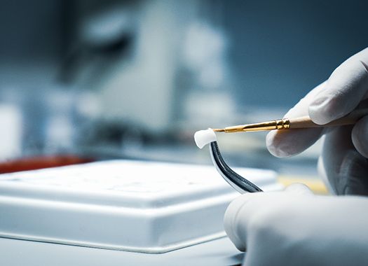 A lab worker making a dental crown