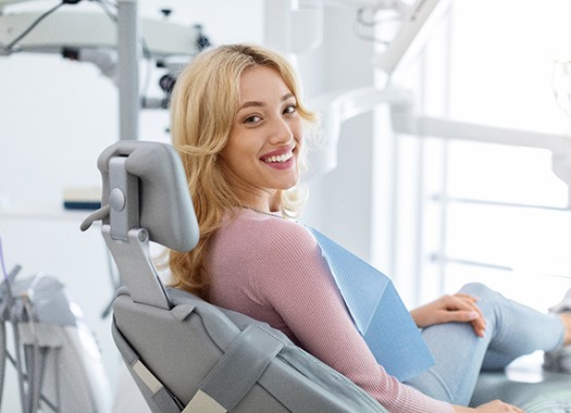 A smiling woman sitting in a dental chair
