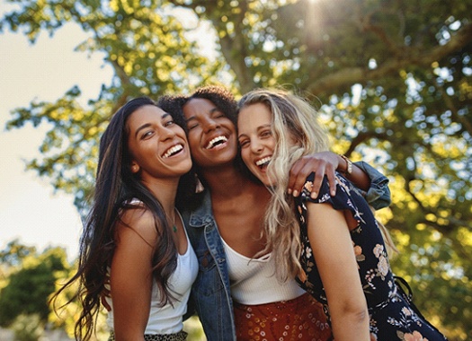 friends laughing and hugging each other