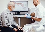 Denture dentist in New Orleans showing patient dentures 