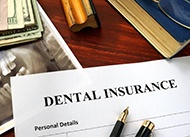 Dental insurance paperwork on wooden desk 