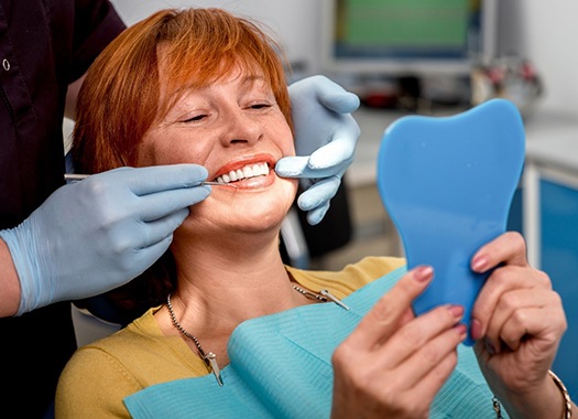 patient smiling after getting dentures in New Orleans