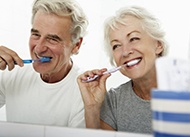 couple brushing their teeth together 