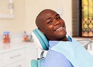 A man seated in the dentist’s chair preparing to undergo an initial consultation for dental implant placement