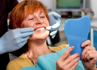 patient smiling after getting dental implants in New Orleans