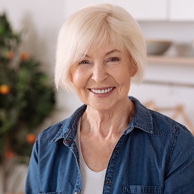 elderly woman smiling with dental implants in New Orleans 