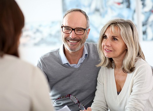 elderly couple at a dental implant consultation