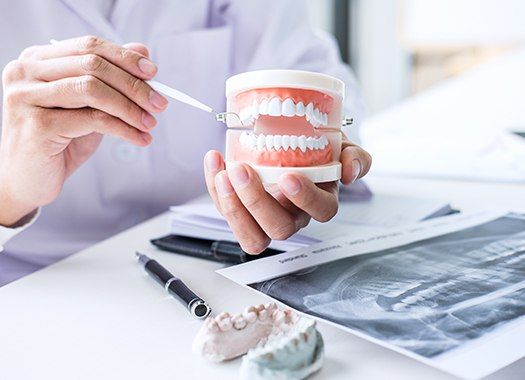 Dentist pointing to smile model