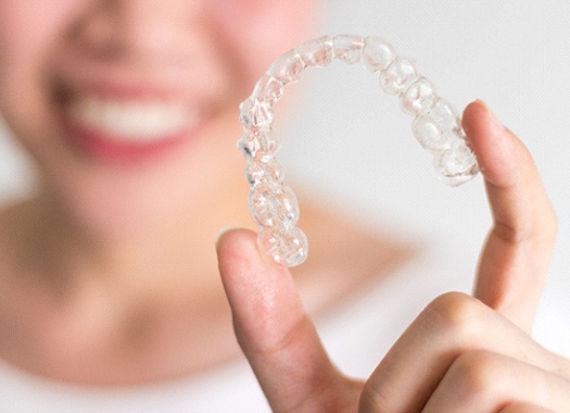 Person holding Invisalign in Uptown New Orleans