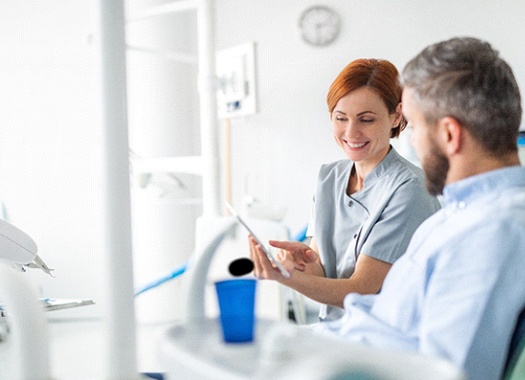 Dental team member explaining Perio Protect to patient