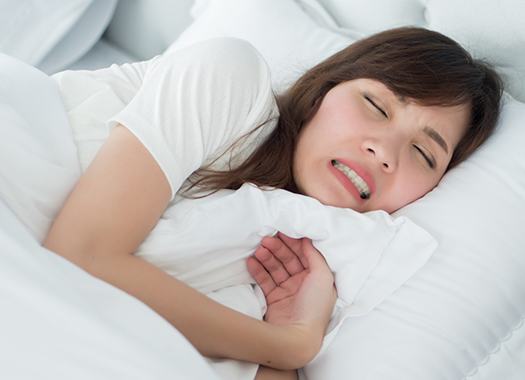 Woman grinding her teeth in her sleep