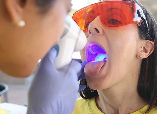 Dentist performing oral cancer screening