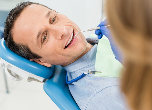 Man in dental chair for smile makeover consultation