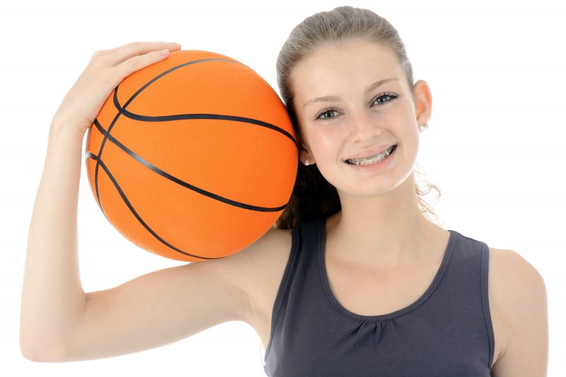 Girl with braces holding basketball