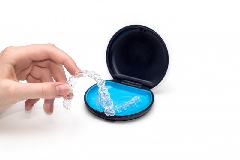 An Invisalign tray next to its case
