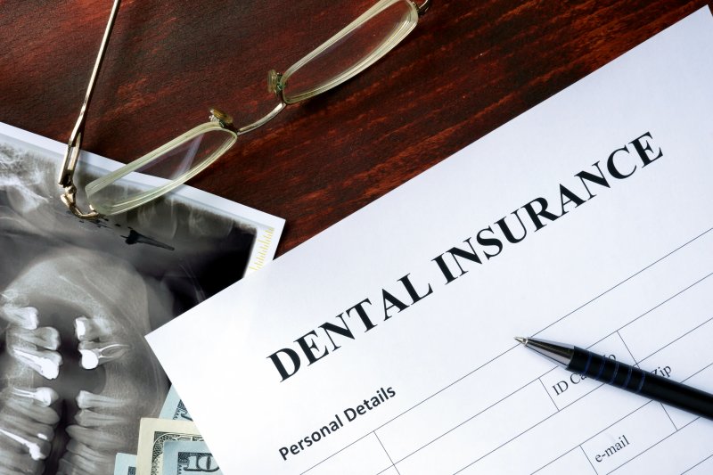 A dental insurance form on a wooden table